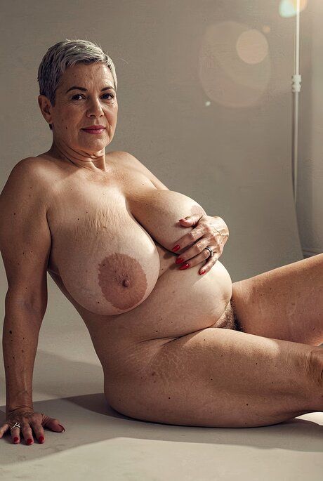 Naked granny with short hair and big breasts displaying her sexy body - #13