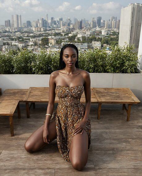 Pretty black girl with her hair braided stands naked on a rooftop patio - #5