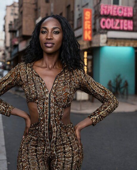 Hot African woman models nude and non nude clothing on a city street - #10