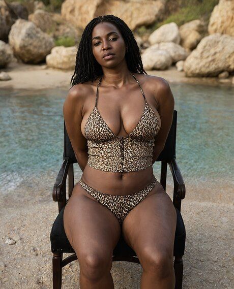Ebony solo girl removes her swimwear to pose nude on boulder stoned beach - #5