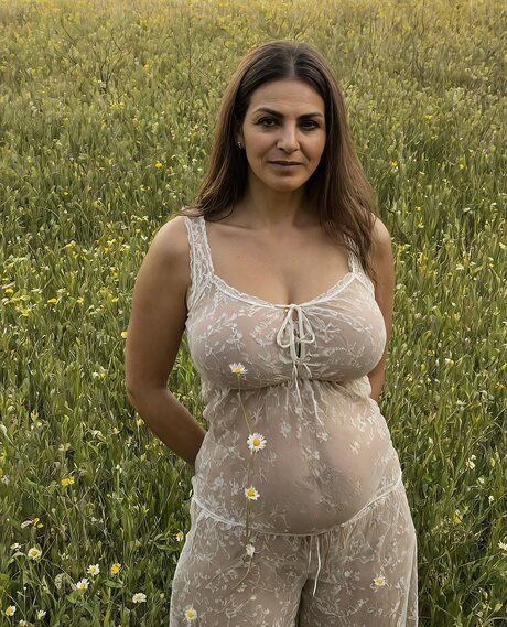 Older woman strikes tempting nude poses in a field of wildflowers - #7