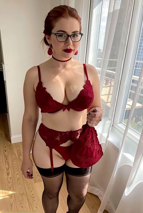 Solo girl with red hair and glasses poses in a red brassier and garters - #4